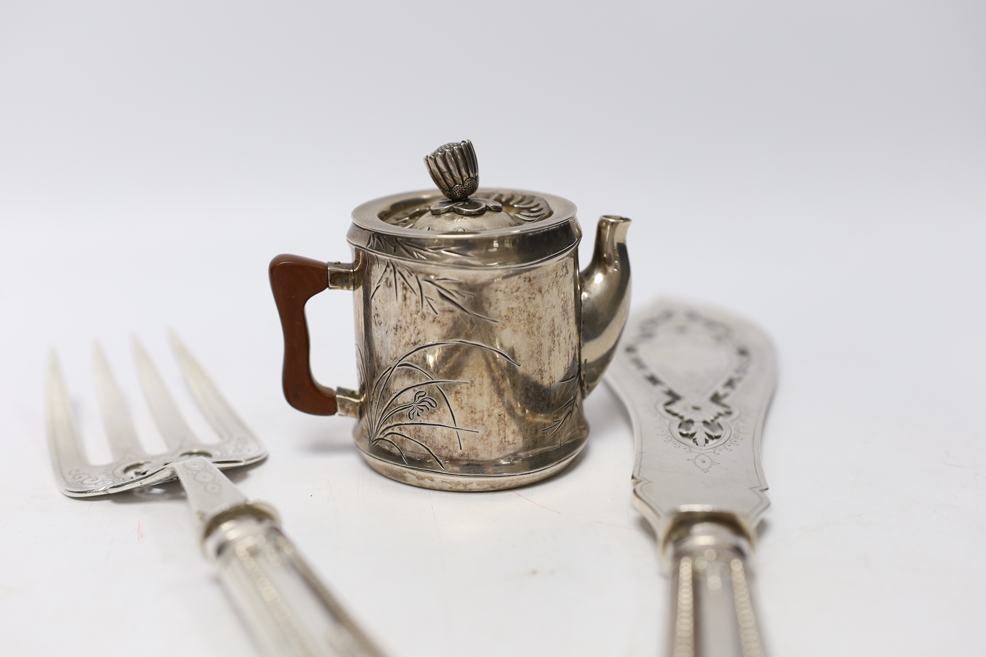 A pair of Victorian silver fish servers, Martin, Hall & Co, Sheffield, 1850, knife 33.1cm, together with a Japanese white metal miniature teapot, with bamboo decoration and lacquered handle.